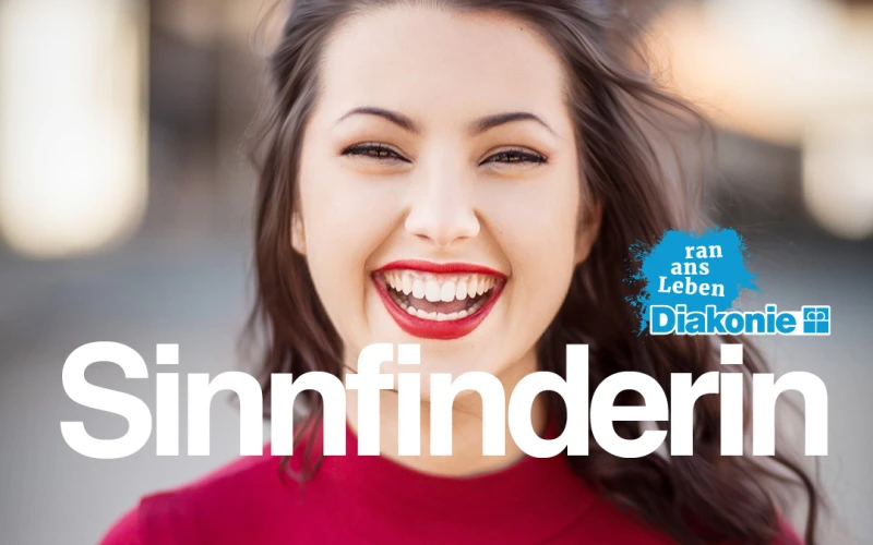 L&auml;chelnde junge Frau in rotem Oberteil mit gro&szlig;em Schriftzug "Sinnfinderin". Werbeplakat der Diakonie f&uuml;r FSJ, Praktikum und duales Studium mit blauem Diakonie-Logo.
